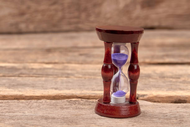 istock Stylish hourglass on wood background. 972627440