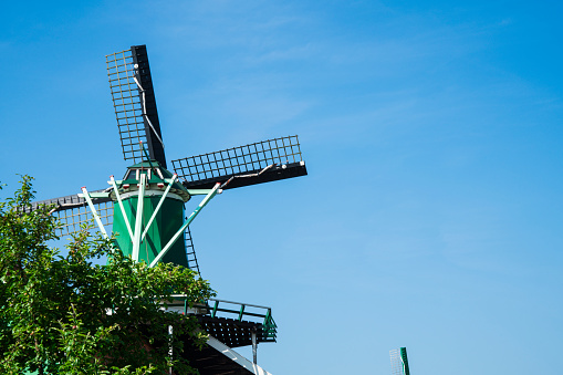 green wind mill in touristic village Zaanse Schans, Holland