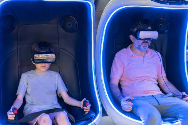 Happy family! father and her son using virtual reality glas