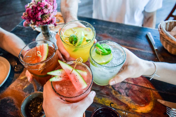 780298633 Friends toasting, saying cheers holding tropical blended fruit margaritas.  Watermelon and passionfruit drinks.; Shutterstock ID 780298633 margarita stock pictures, royalty-free photos & images