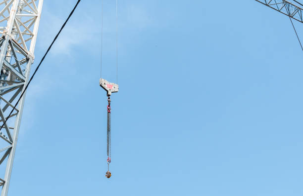 istock Tall heavy construction crane industrial hook with blue sky background. 972655554