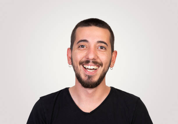 istock Laughing young man on gray background 972658520