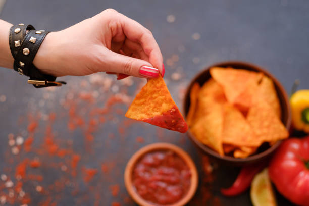 istock homemade tortilla nacho chips hand sauce dip 972658680
