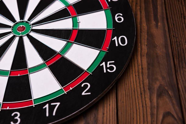 istock Darts board. Target on wooden table background. 972658742