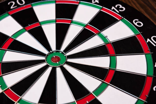 istock Darts board. Target on wooden table background. 972658884