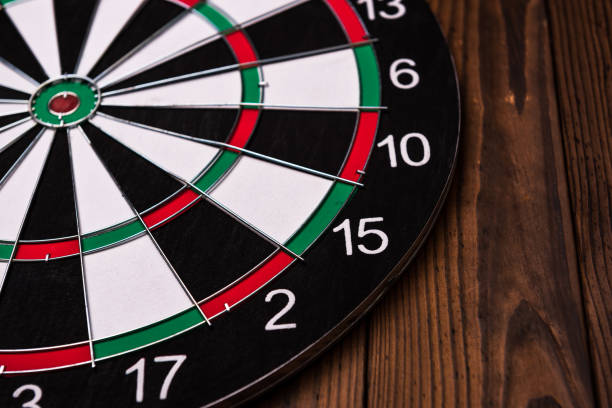 istock Darts board. Target on wooden table background. 972658896