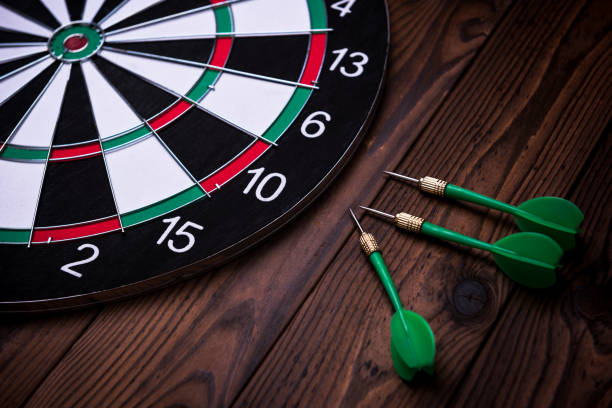 istock The darts on wooden background 972659082