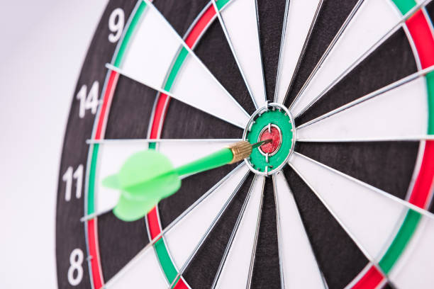 istock On the Target. Green dart hitting the target. 972659174