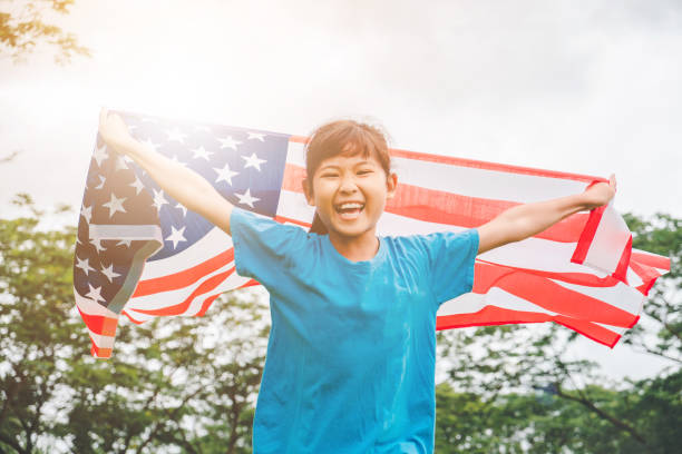 happy kid little child running with american flag usa celebrate 4th of july - child flag fourth of july little girls imagens e fotografias de stock