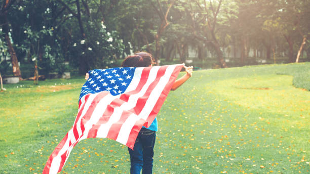 happy kid little child running with american flag usa celebrate 4th of july - child flag fourth of july little girls imagens e fotografias de stock