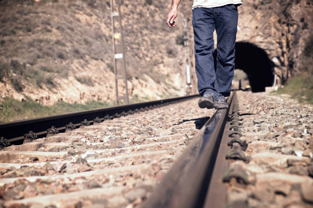 Young man doing balances on a train track, Zaragoza Province, Aragon in Spain.