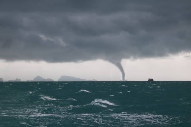 istock Tornado and storm cloud in the sea while the ship is sailing 972672582