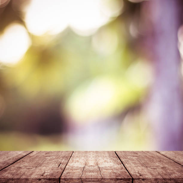 istock empty wooden on blurred nature backdrop. Wood table top. can used for display or montage your products 972683516
