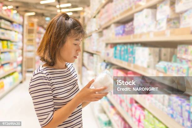 Asian Woman Shopping Sanitary Napkin At The Supermarket Stock Photo - Download Image Now