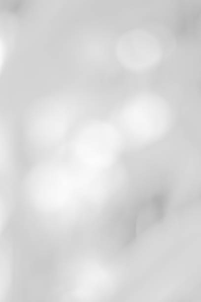 istock white blurred backdrop of nature, circle white wallpaper, gray bokeh background 972695532