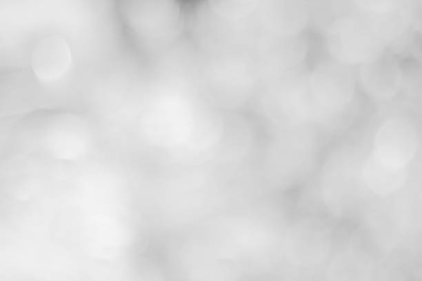 istock white blurred backdrop of nature, circle white wallpaper, gray bokeh background 972695594