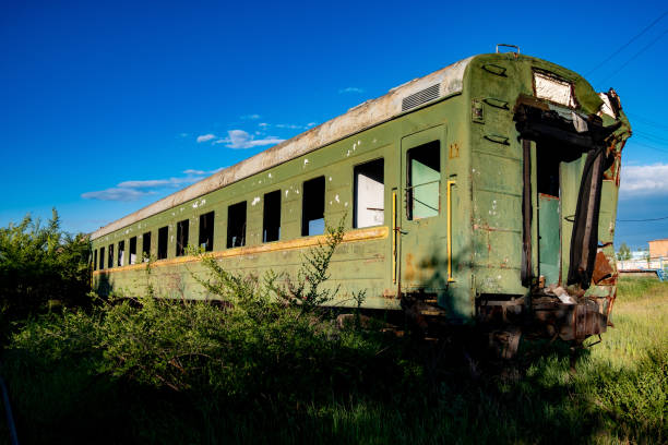 istock Abandoned train. Forgotten overgrown railway. Old rusty railway carriage 972704498