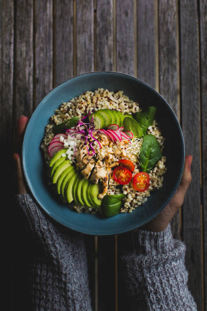 istock Cropped Hands Holding Salad Bowl On Table 972704974