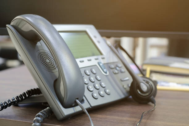 istock close up soft focus on telephone devices at office desk for customer service support concept 972705712