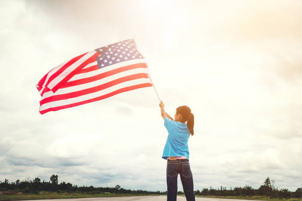 happy kid little child standing with american flag usa celebrate 4th of july - child flag fourth of july little girls imagens e fotografias de stock