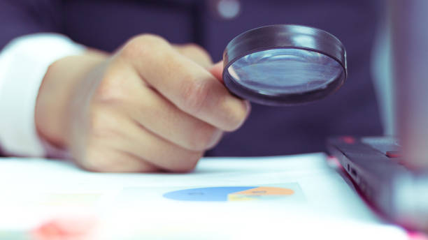 istock Businessmen use a magnifying glass to analyze the company's data and statistics from the chart. 972721718