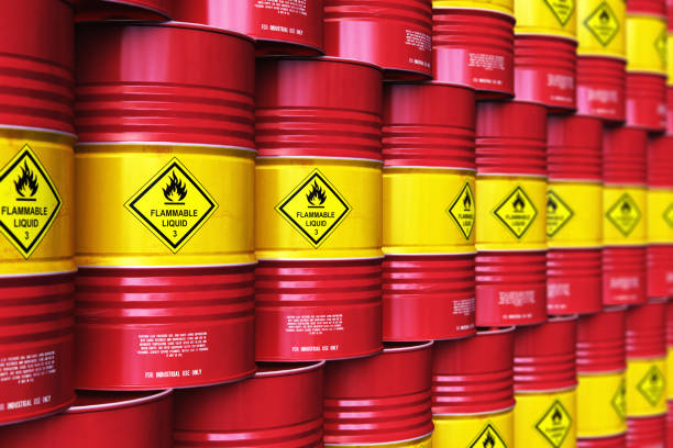 istock Group of rows of red stacked oil drums in storage warehouse 972721828