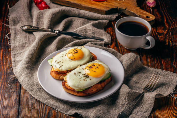 istock Bruschettas with vegetables and fried eggs with cup of coffee 972722244