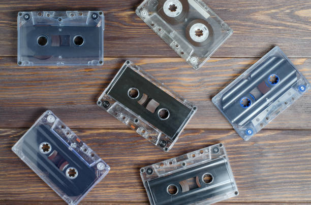 istock Old audio cassettes on wooden background 972729544