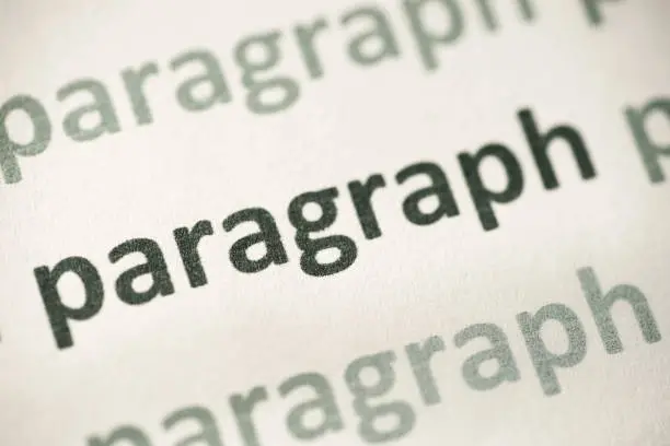word paragraph printed on white paper macro