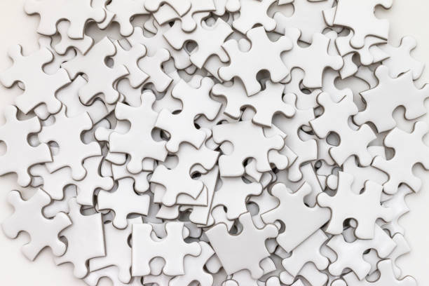 istock Unfinished white jigsaw puzzle on white background 972743484