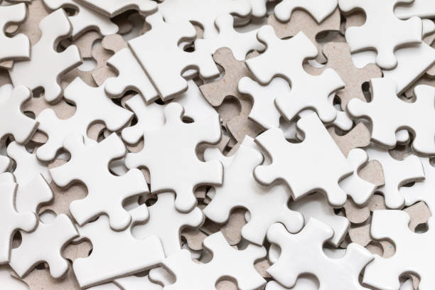 istock Unfinished white jigsaw puzzle on white background 972743486