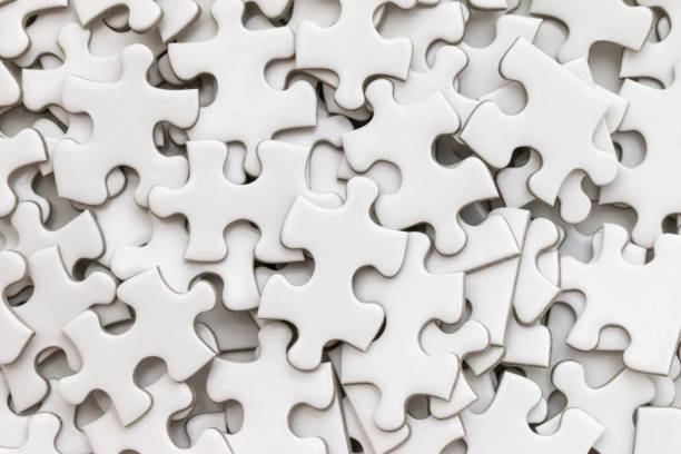 istock Unfinished white jigsaw puzzle on white background 972743580