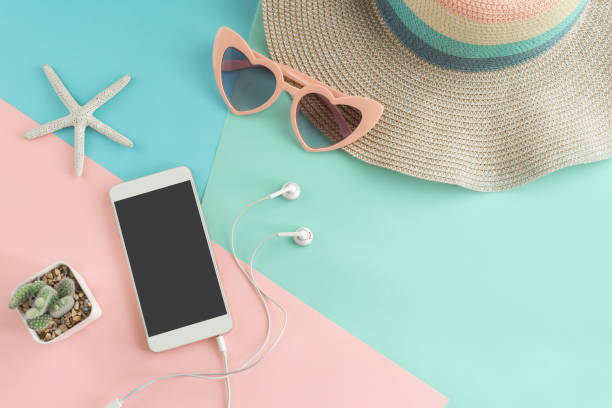 istock Women's accessories items with smart phone on pastel colors background, Summer vacation concept 972746132