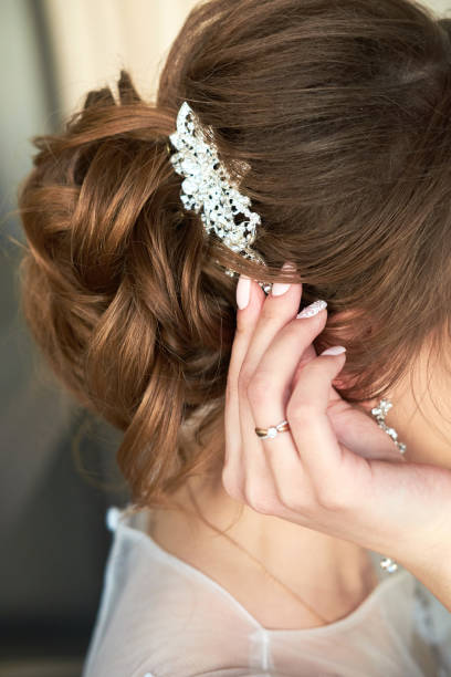 istock bride fastens the barrette in her hair 972749162