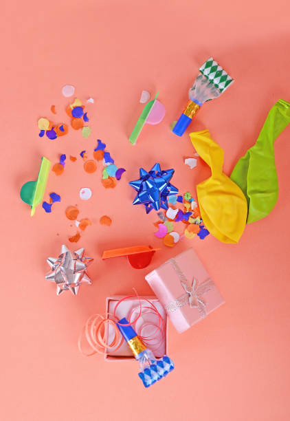 istock Red gift box with party confetti, streamers and noisemakers 972754552