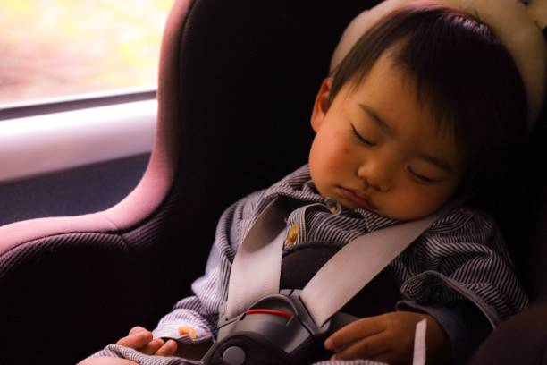 One boy asleep in the car stock photo