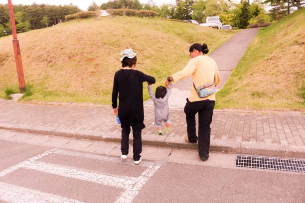 istock Japanese family holding son 972760716