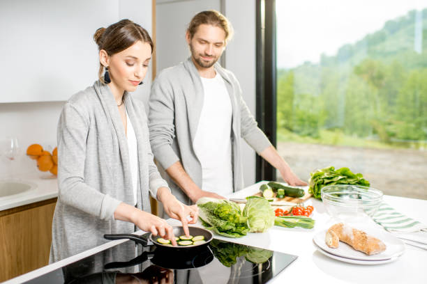 istock Couple cooking food at the kitchen home 972760746