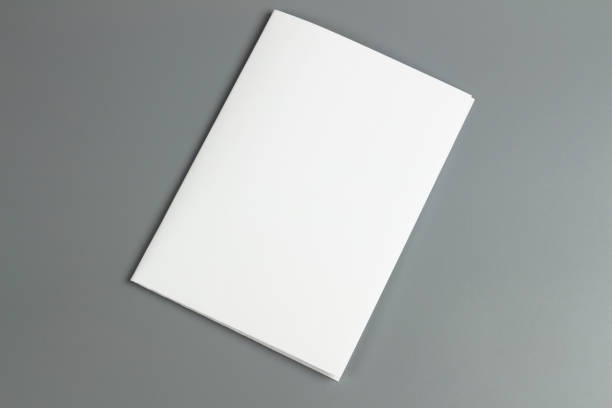 istock Blank portrait mock-up paper. brochure magazine isolated on gray, changeable background / white paper isolated on gray 972761016