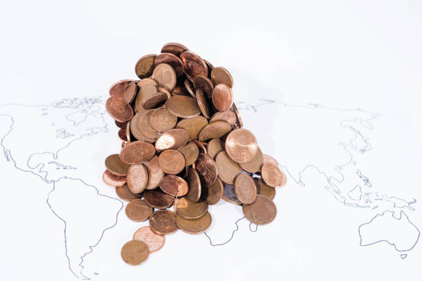 istock A lot of coins on World Map. 972764032