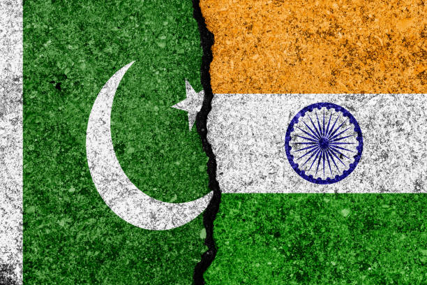 Flags of India and Pakistan  painted on cracked wall background/India - Pakistan relations concept stock photo