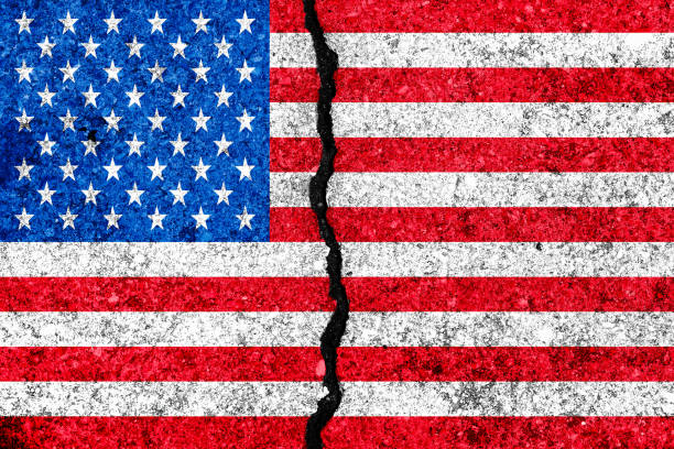 istock United States flag painted on cracked wall background/USA divided concept 972766372