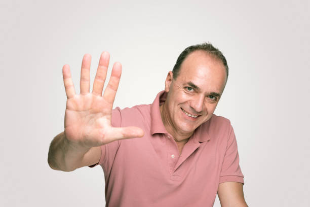 istock Handsome adult man  showing number five by fingers 972770024