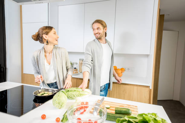 istock Couple cooking food at the kitchen home 972770236