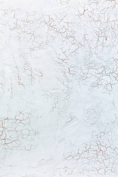 Cracks in the white wall plaster. Light gray background with craquelure effect. cracked white stock pictures, royalty-free photos & images