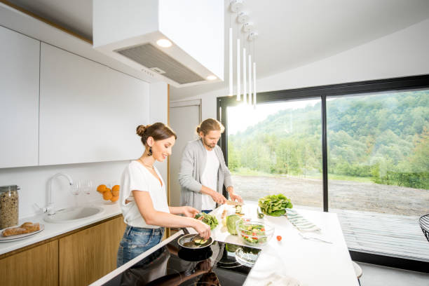 Couple cooking food at the kitchen home