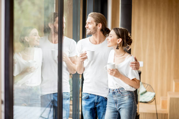 istock Couple standing near the window indoors 972775600