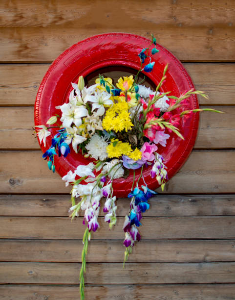 Vertical garden with used tyre with plants flowers inside