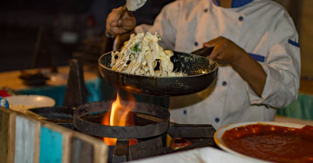 istock Preparing pasta with white cream in frying pan on flames 972781448