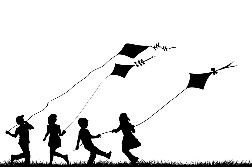 Children silhouettes playing with kites